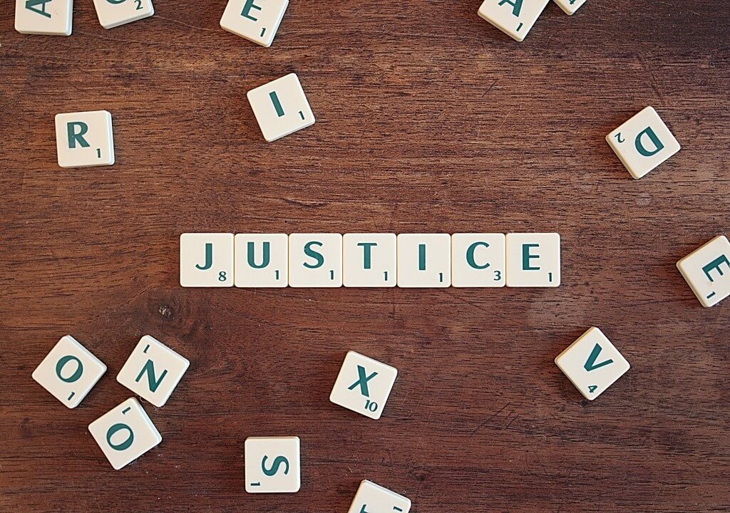 justice spelled using scrabble